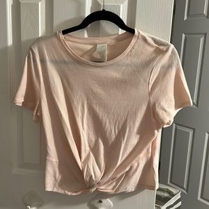 Light pink crop top Size M with a twist at the bottom